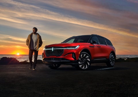 A person is shown next to a 2025 Lincoln Nautilus® SUV as the Lincoln Embrace sequence takes place. | Apple Lincoln Apple Valley in Apple Valley MN