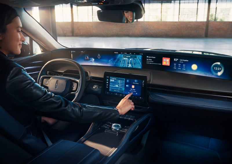 The driver of a 2025 Lincoln Nautilus® SUV interacts with the center touchscreen. | Apple Lincoln Apple Valley in Apple Valley MN